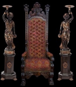 Nineteenth century throne chair, 8 feet tall, flanked on either side by Venetian blackamoors, also 19th century. Historical Estates Auctions image